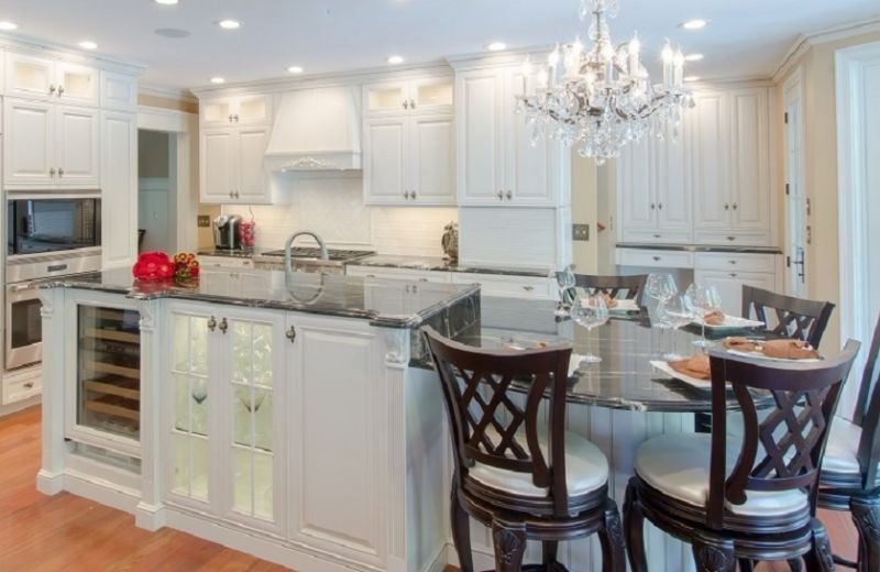 Bold dark countertops contrast the white cabinets.