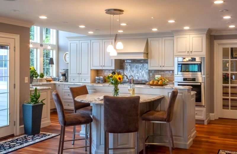 Grey accents compliment the white cabinets in this two toned kitchen.