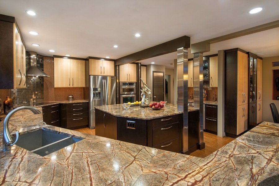 Black cabinets meet this artistic grey countertop with brown accents. 