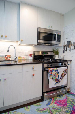 A kitchen with a stove and a refrigerator
