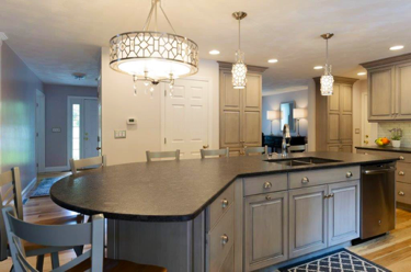 This elegantly designed kitchen features an island that seats up to 6 guests! Hanging lights brighten up this space while creating a sophisticated touch.